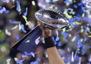 Quarterback Russell Wilson of the Seattle Seahawks holds the Vince Lombardi Trophy following victory over the Denver Broncos in Super Bowl 48 at MetLife Stadium in East Rutherford, New Jersey, on February 2, 2014. Seattle's Russell Wilson threw for two touchdowns and the Seahawks' ferocious defense overwhelmed Denver's record-setting offense, forcing three turnovers on the way to a stunning 43-8 victory in Super Bowl 48. AFP PHOTO / Timothy A. CLARY (Photo credit should read TIMOTHY A. CLARY/AFP/Getty Images)