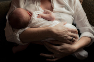 Mother holding newborn baby in arms.