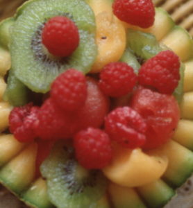 Close-up of a fruit bowl, made from a cut cantaloupe, that holds raspberries, kiwi slices, and other fruits, Washington DC, 1981. (Photo by Joseph Klipple/Getty Images)