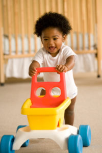 A baby walking with push cart toy