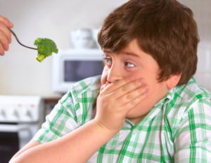 Overweight boy hates broccoli