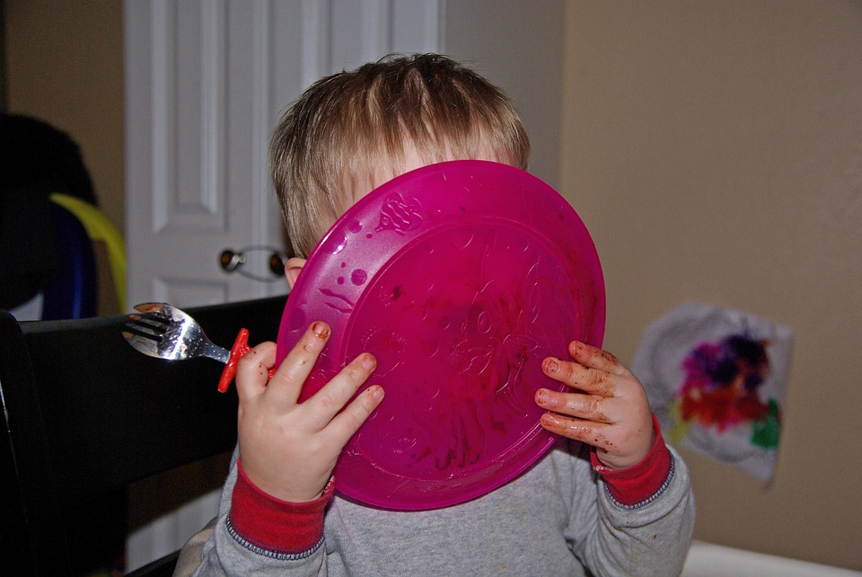 it's just a phase: little boy licking his plate clean