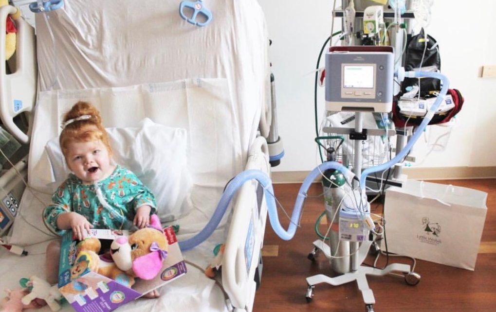 child receiving a birthday gift during a hospital stay courtesy of Little Wishes
