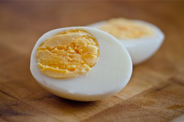 perfectly hard boiled egg cut in half to show yellow yolk
