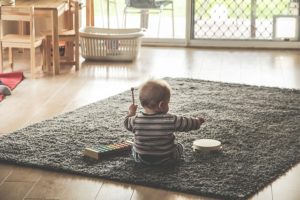 baby playing alone with toys