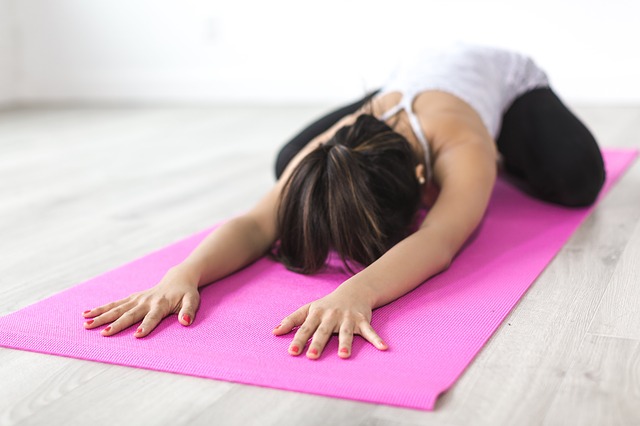woman practicing yoga in child's pose trying to find balance in life