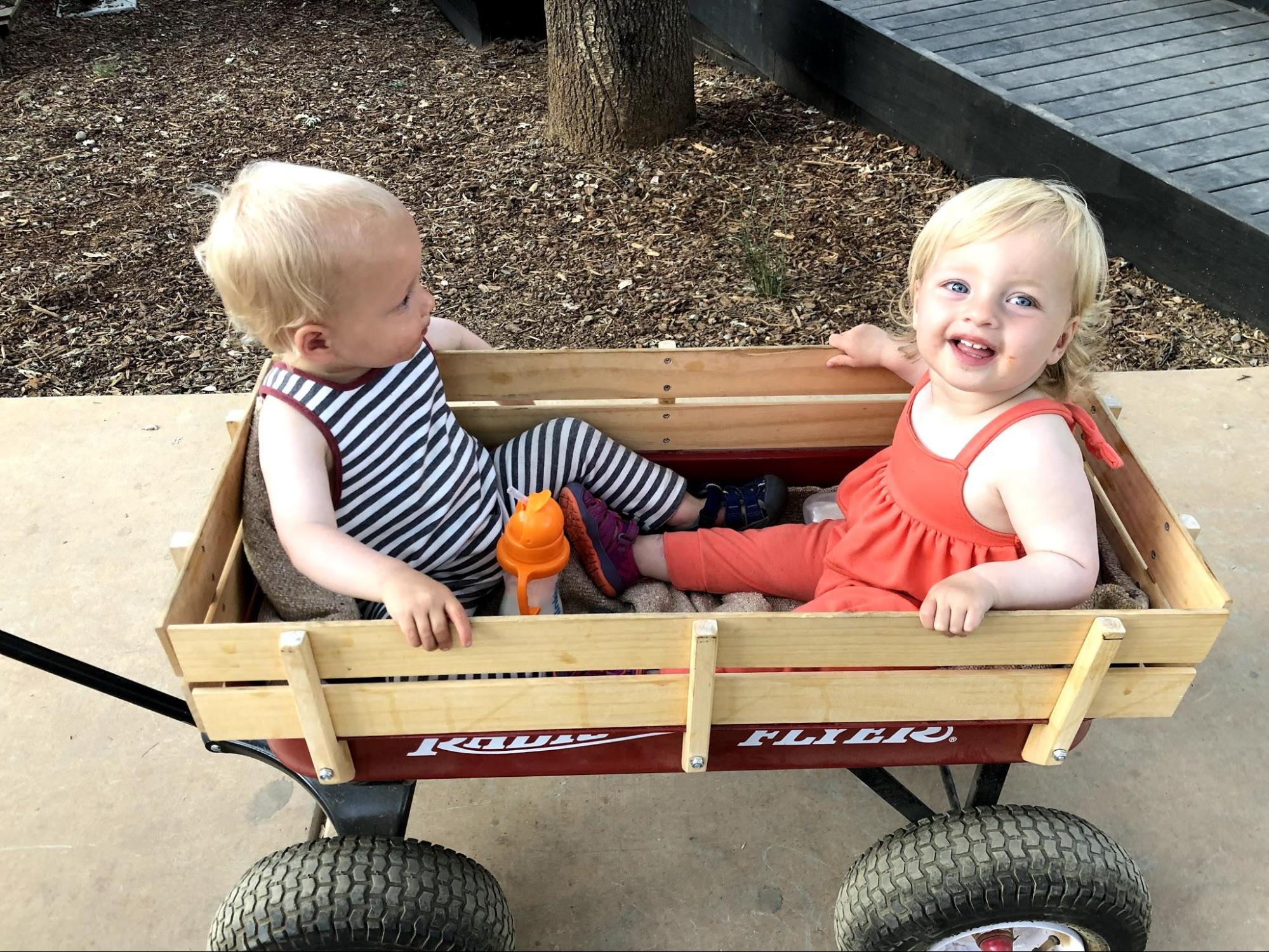 twin toddlers leaving class in a wagon