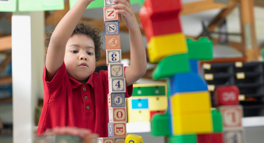 child playing with blocks at preschool