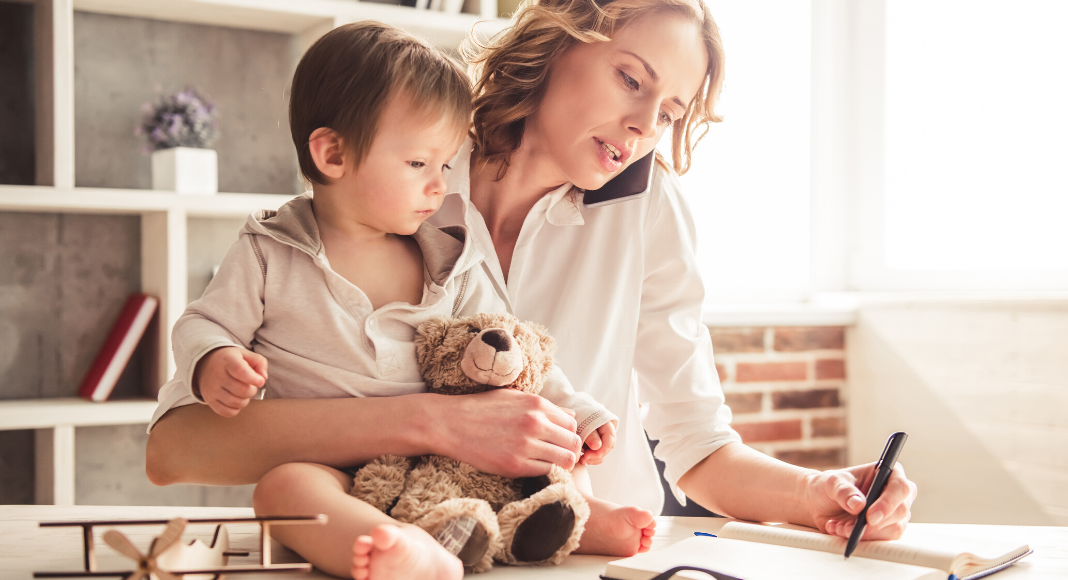 Mother working at home and caring for child