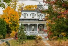 How to Make an Older House Feel More Modern A large historic house with tall windows and a small porch. The trees around the house are changing colors.
